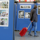 Un viajero contempla una de las fotografías de la exposición en la estación de Campo Grande.-J.M. LOSTAU