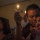 People attend a Christmas service at Rahmat Pentecostal Church in Carita  Indonesia  Christmas celebrations traditionally filled with laughter and uplifting music were replaced by somber prayers for tsunami victims in Indonesia-Fauzy Chaniago  / AP