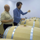 Fernando Galindo y su padre Fidencio prueban el vino de una barrica.-J.L.C.