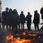 Un grupo de refugiados se protege del frio en Bergrado, Serbia.-EFE / ULEJMANOVIC