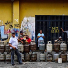 Ciudadanos hacen cola para para reemplazar los bidones de gas propano vacíos en el barrio Las Minas de Baruta, en Caracas.-RONALDO SCHEMIDT (AFP)