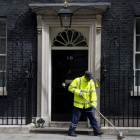 Un barrendero limpia la entrada del número 10 de Downing Street, la sede del primer ministro británico.-JUSTIN TALLIS / AFP