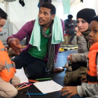 Fotografia cedida por la ONG Sea-Watch que muestra a Nasreen  2d  y a su hijo Zizou  i  junto a otros inmigrantes a bordo del buque Sea Watch 3 en el mediterraneo el 23 de diciembre de 2018.-SEA WATCH