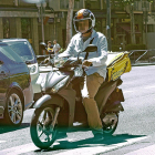 Un ‘rider’ de Glovo con su moto, ayer en el Paseo Zorrilla de Valadolid.-MIGUEL ÁNGEL SANTOS / PHOTOGENIC