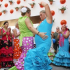 Unas mujeres bailan en un corrillo en el recinto ferial de Málaga, en las fiestas de agosto.-Foto: ARCHIVO / M. POZO