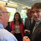 El 'president' Carles Puigdemont y la jefa de la oposición, Inés Arrimadas, junto al 'conseller' Josep Rull, en el Euromed Barcelona-Valencia.-EL PERIÓDICO