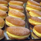 Los abisinios, uno de los dulces más emblemáticos de Valladolid, destacan por su masa frita, forma ovalada y relleno cremoso, una receta tradicional muy popular en Medina de Rioseco.
