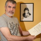 Olmo Gómez con los papeles que le reconocen como 'bebe robado' y detrás una caricatura de su madre biológica