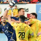 El estadounidense Donlin es agarrado por dos rivales en su debut con el Recoletas.