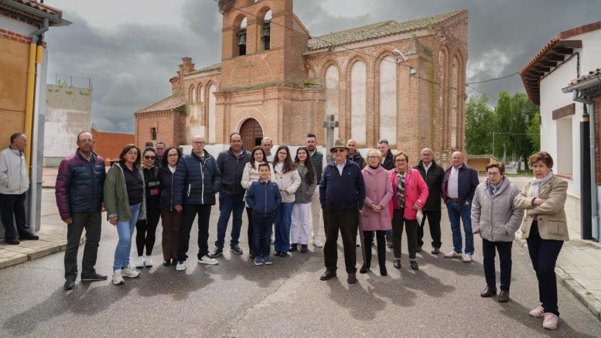 Varios vecinos posan delante de la iglesia de San Juan Bautista.