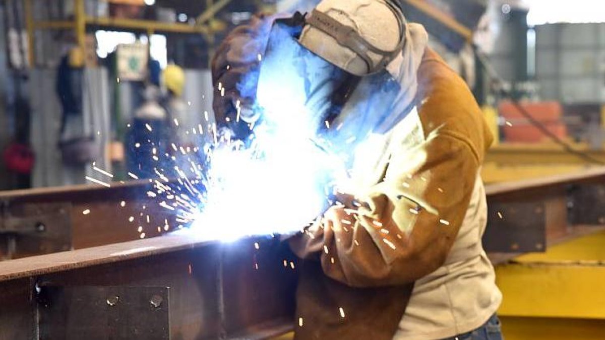 Un operario suelda una estructura en una industria metalúrgica.