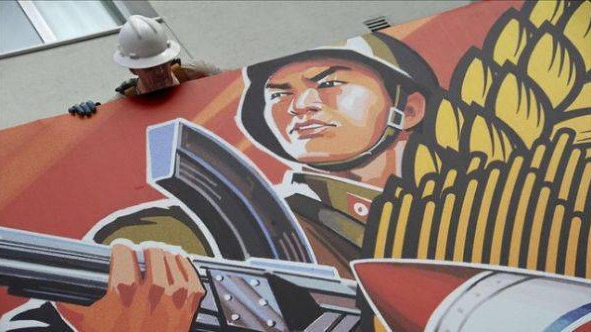 Un trabajador sacando el cartel de 'The Interview', la película cancelada de Sony, el pasado jueves en Hollywood, California-