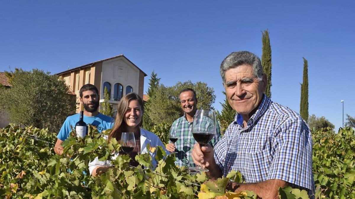 Moisés Gamazo en primer plano, seguido de Esther Pérez, Jesús Herranz y Víctor en el viñedo que está delante de la fachada de la bodega.-