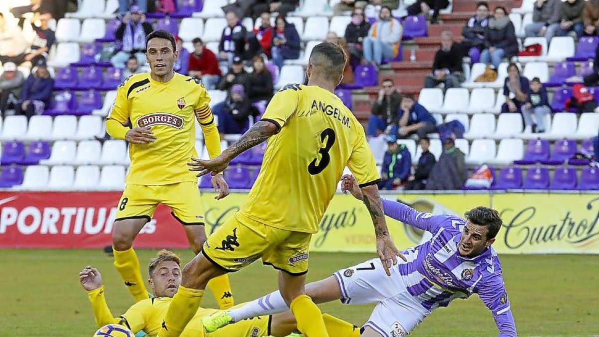 Villar cae derribado por Olmo, ante la mirada de Ángel y Folch (8), durante el Real Valladolid-Reus del viernes.-PABLO REQUEJO