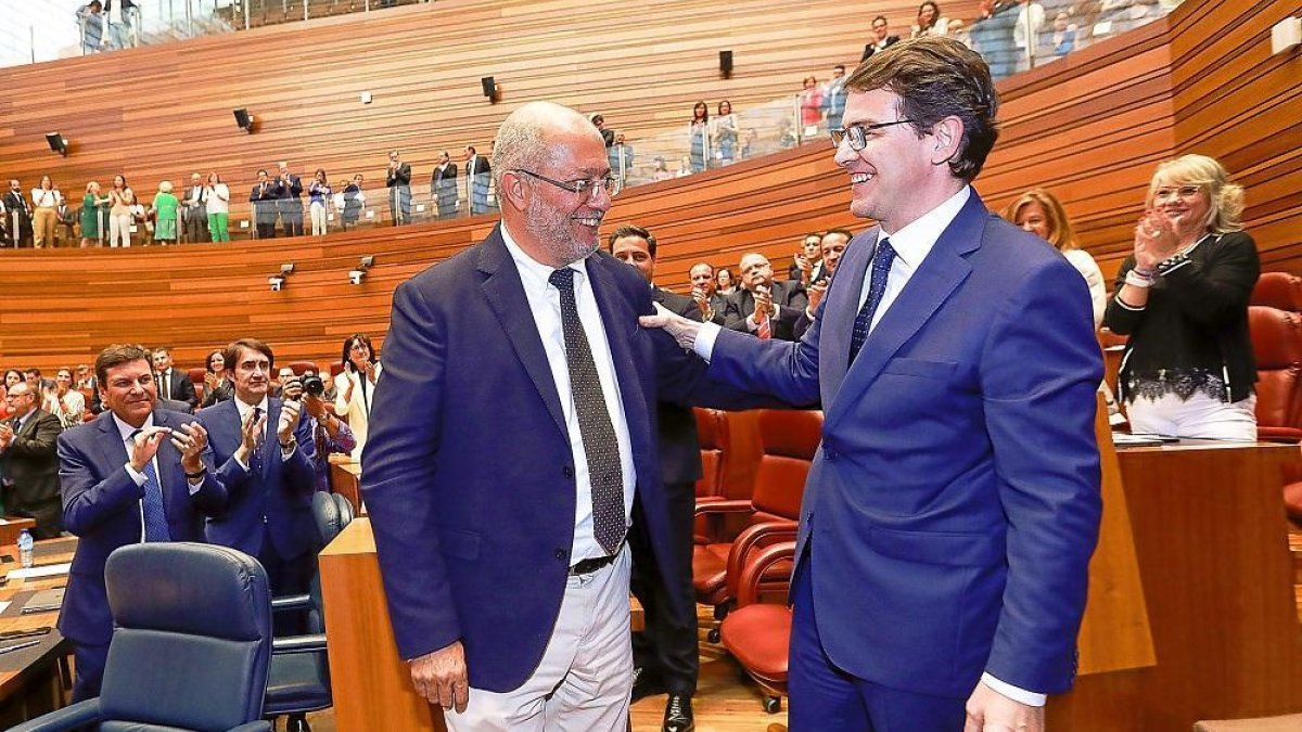 El ‘popular’ Alfonso Fernández Mañueco saluda al líder de Cs, Francisco Igea, al término de la votación de investidura que le convirtió en presidente.-J. M. LOSTAU