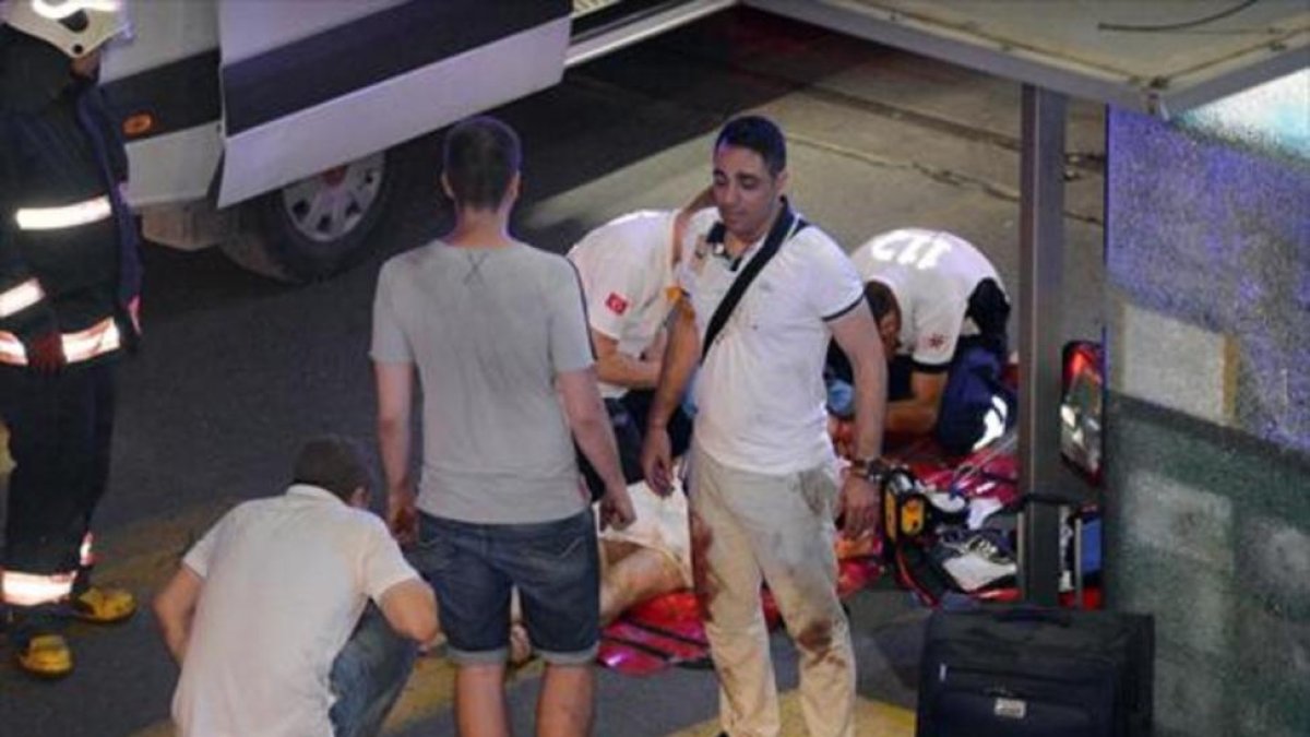 Víctimas, policías y personal sanitario, en el exterior del aeropuerto Atatürk de Estambul, después del atentado de anoche.-REUTERS / ISMAIL COSKUN