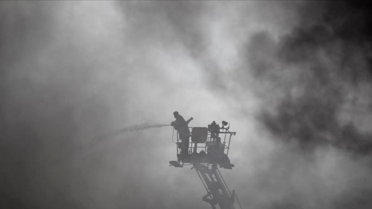 Un bombero trabaja en el lugar del incendio, una fábrica de embalajes de cuatro plantas.-AP