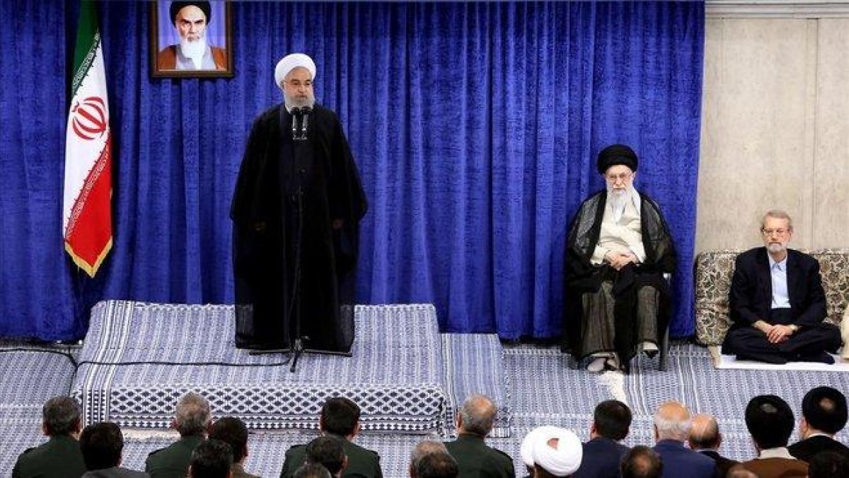 El líder supremo iraní, Ali Jamenei, sentado a la derecha, escucha el discurso del presidente del país, Hasán Rohaní, el martes en Teherán.-AFP / HO KHAMENEI