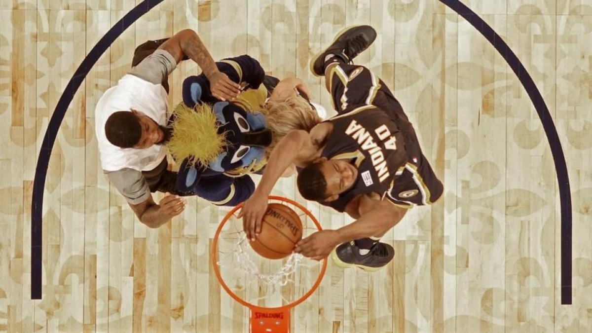 Glenn Robinson III salta por encima de Paul George (2,06), la mascota de los Pacers y una animadora del equipo para ganar el concurso de mates del All Star de Nueva Orleans.-EFE / GERALD HERBERT