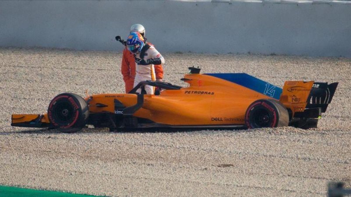 Alonso sale del coche en Montmeló tras perder una rueda.-EFE / ENRIC FONTCUBERTA