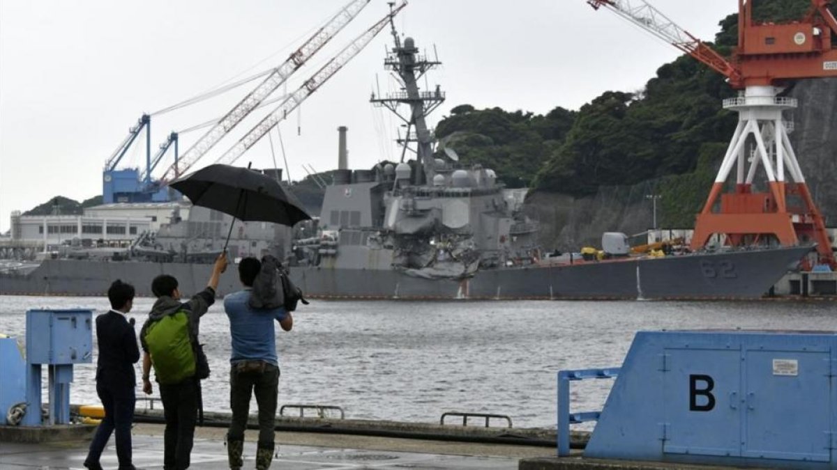 Periodistas japoneses graban los daños en el 'USS Fitzgerald' tras la colisión, en la base naval de Yokosuka, al sur de Tokio, el 18 de junio.-EFE / FRANCK ROBICHO