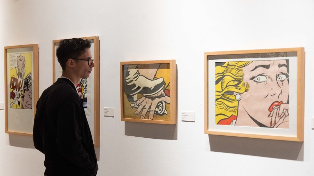 Un joven contempla varias obras de la muestra. | PHOTOGENIC