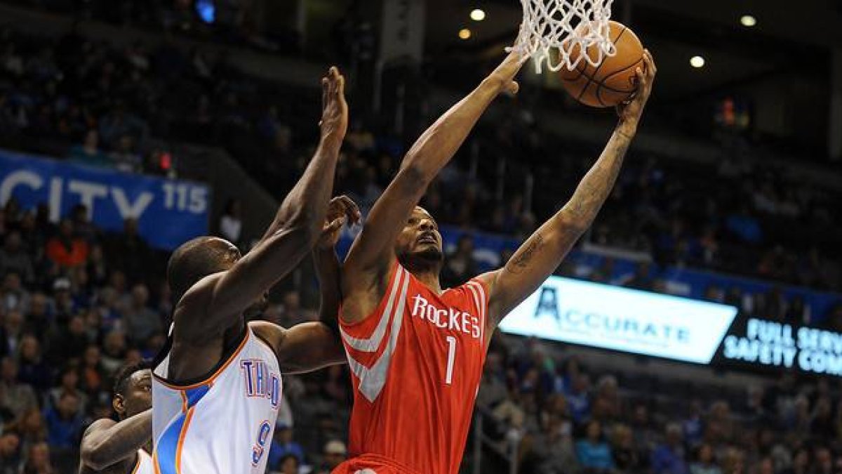 Serge Ibaka (izquierda) trata de impedir la canasta de Trevor Ariza, en un momento del partido entre los Thunder y los Rockets.-MARK D. SMITH