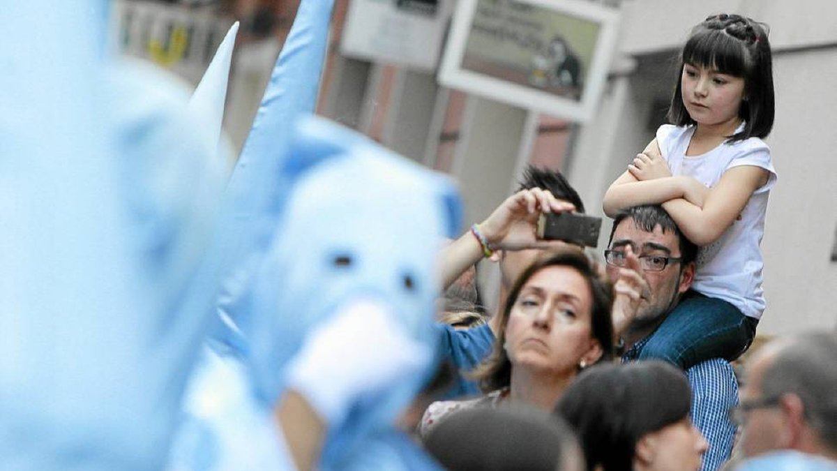 Un joven capta una fotografía al paso de la procesión del Santísimo Rosario del Poder, en Valladolid-J.M.Lostau