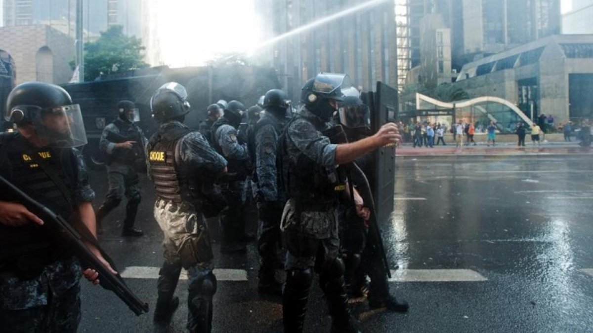 Agentes antidisturbios lanzan agua contra los manifestantes en la avenida Paulista, en Sao Paulo, este viernes.-AFP / GABRIEL SOARES