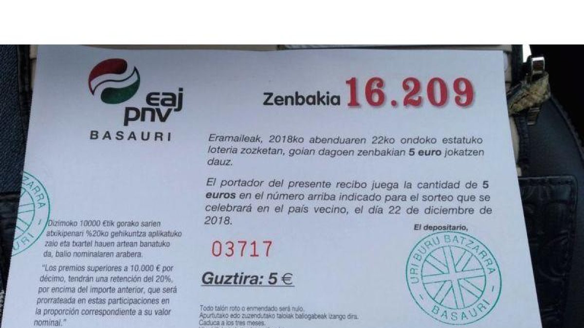 Participación de un cuarto de décimo de la lotería de Navidad emitida para el sorteo de este año por la sede del PNV en Basauri (Vizcaya). En el aviso central, la indicación de que se trata de lotería del país vecino.-G.E.