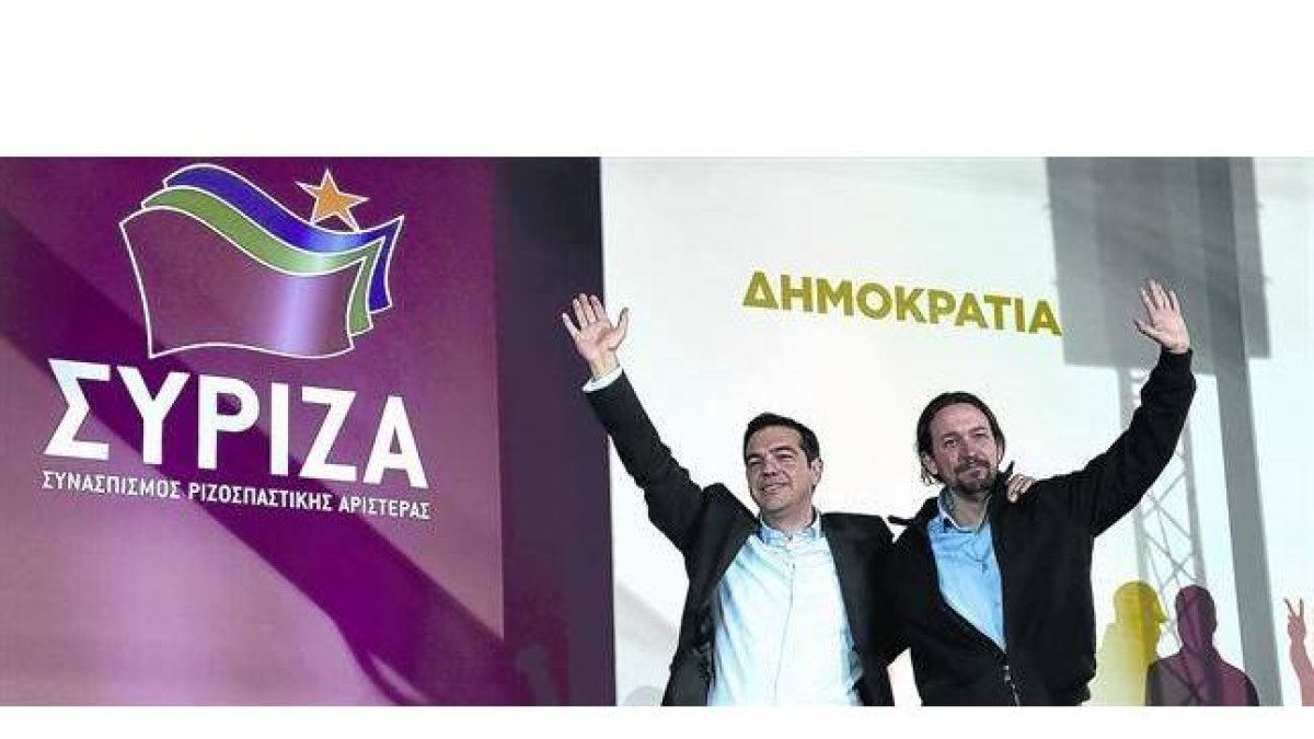 Tsipras, líder de Syriza, se abraza a Pablo Iglesias, su homólogo en Podemos, tras el mitin de ayer en la plaza Omonia de Atenas.-Foto:   AP / LEFTERIS PITARAKIS