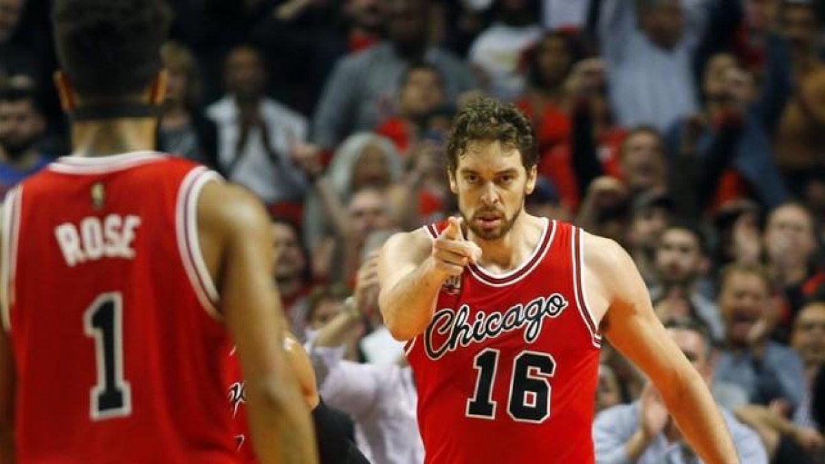 Pau Gasol agradece la asistencia a su compañero Derrick Rose en el duelo ante los Thunders.-AP / JEFF HAYNES