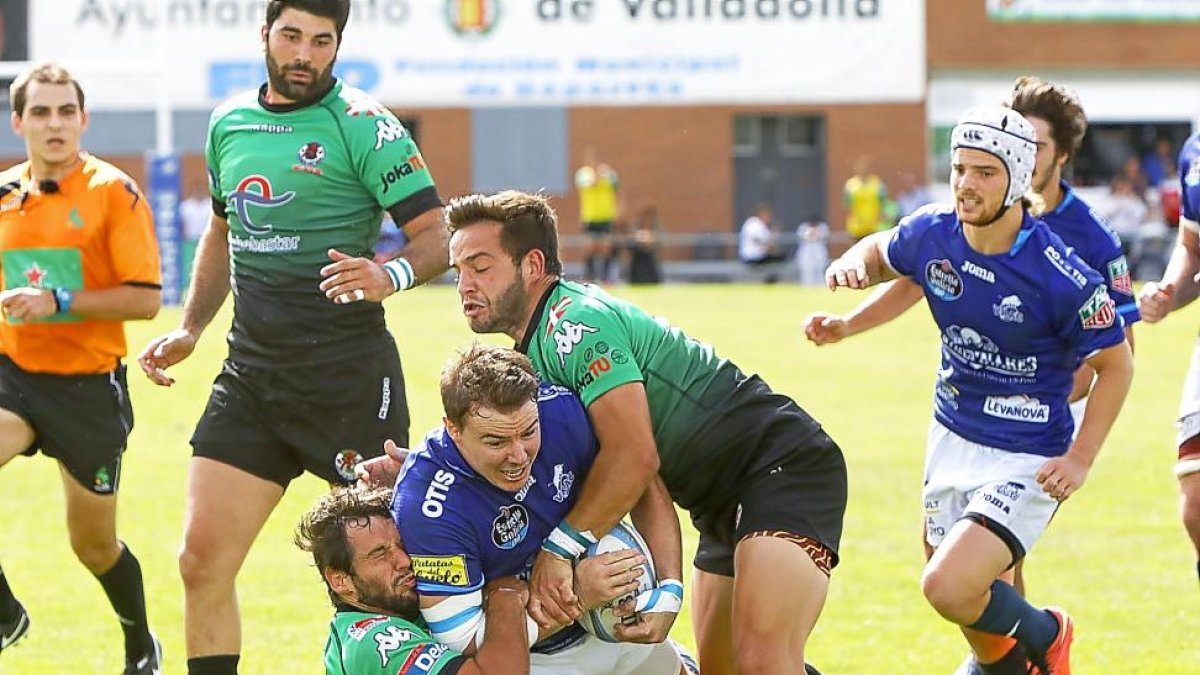 Dos jugadores del Gernika placan a Gareth Griffiths, ayer, en Pepe Rojo.-J. M. LOSTAU