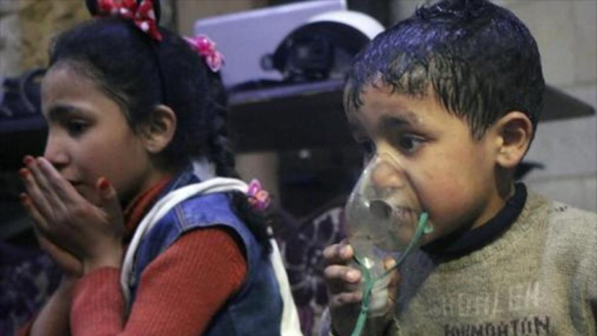 Niños reciben oxígeno, tras el ataque químico.-/ AP
