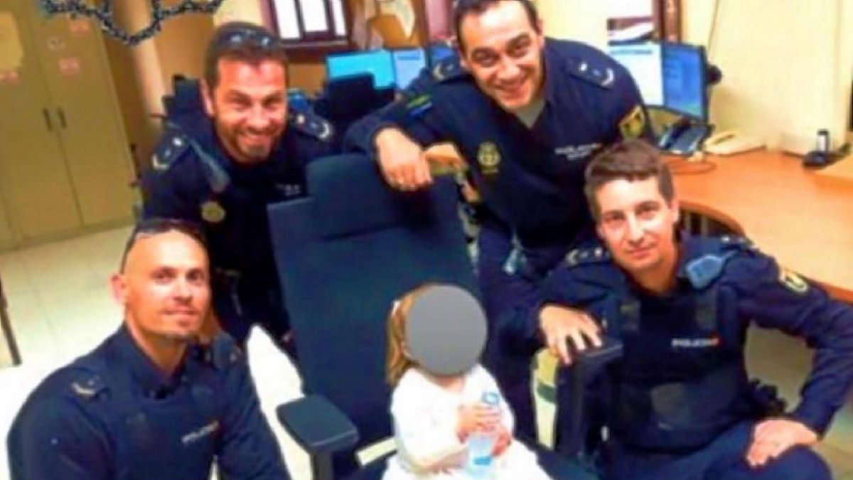 Los policías, con la niña en la comisaría.-CUATRO