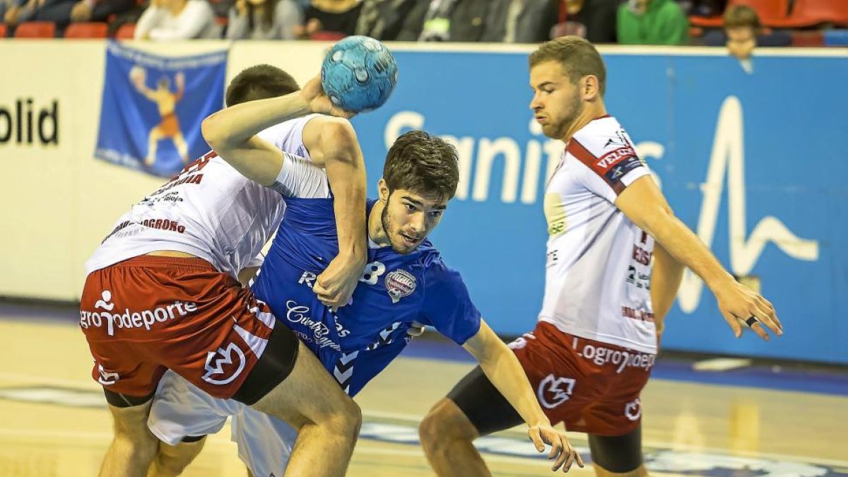 Joel Gómez es agarrado por un jugador del Naturhouse en el amistoso celebrado ayer en Huerta del Rey.-MIGUEL ÁNGEL SANTOS