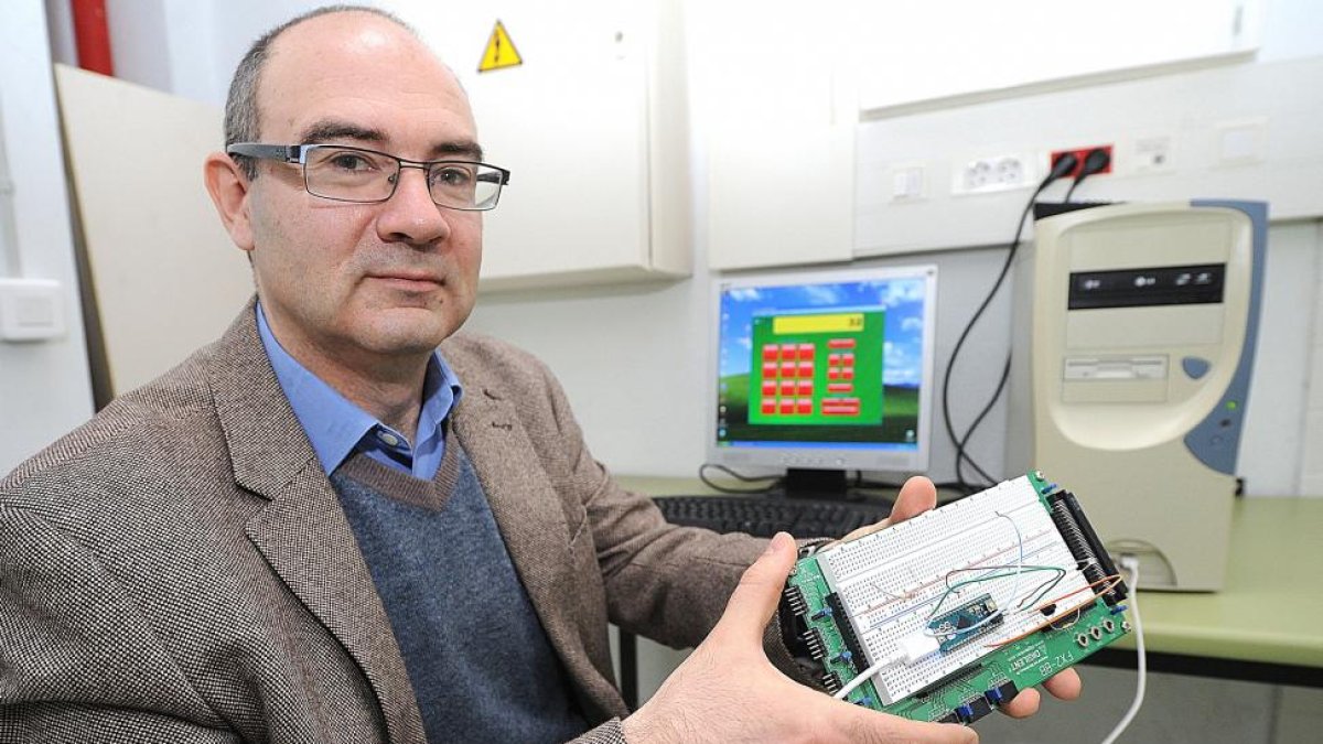 José María Cámara enseña el dispositivo, formado por un microcontrolador y un receptor de infrarrojos, en su fase de desarrollo.-ISRAEL L. MURILLO