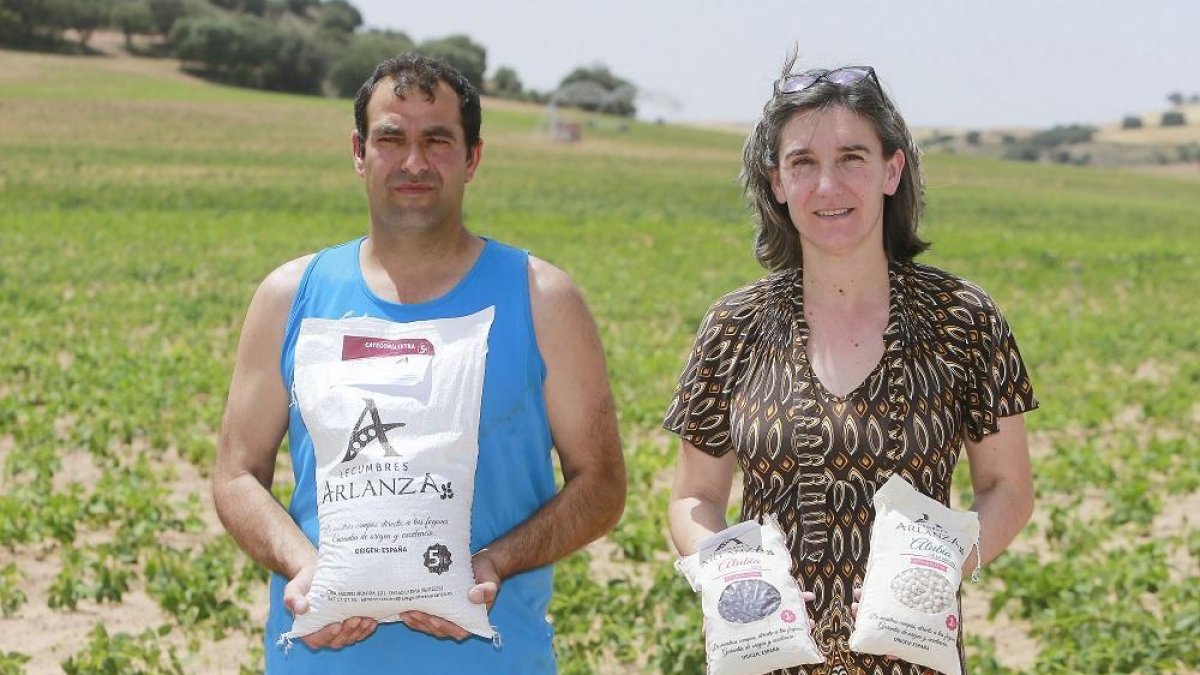 Laureano Porres y Carolina Adrián posan con sacos de diferentes tamaños de Legumbres Arlanza en una finca dedicada al cultivo de alubias.-FOTOS: RAÚL G. OCHOA