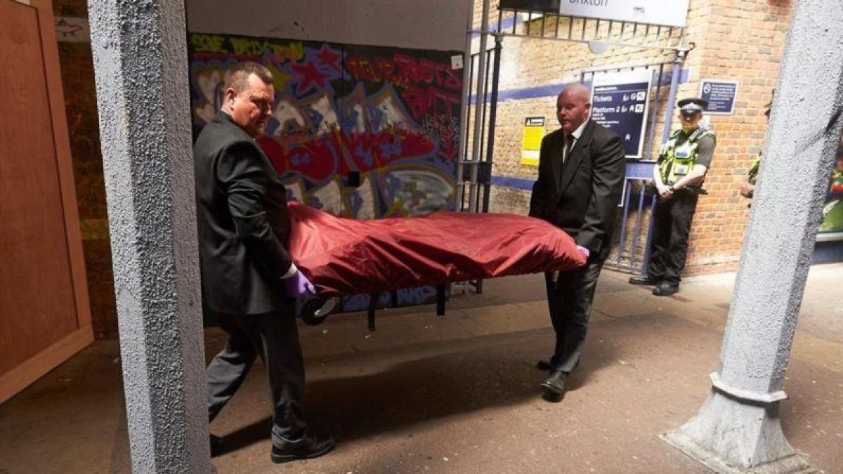 Traslado del cadáver de uno de los tres jóvenes grafiteros atropellados en el sur de Londres.-NIKLAS HALLE N / AFP