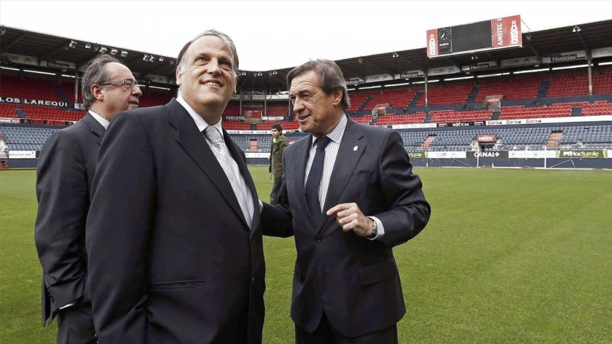 Archanco, a la derecha, junto a Javier Tebas (en el césped de El Sadar-EFE