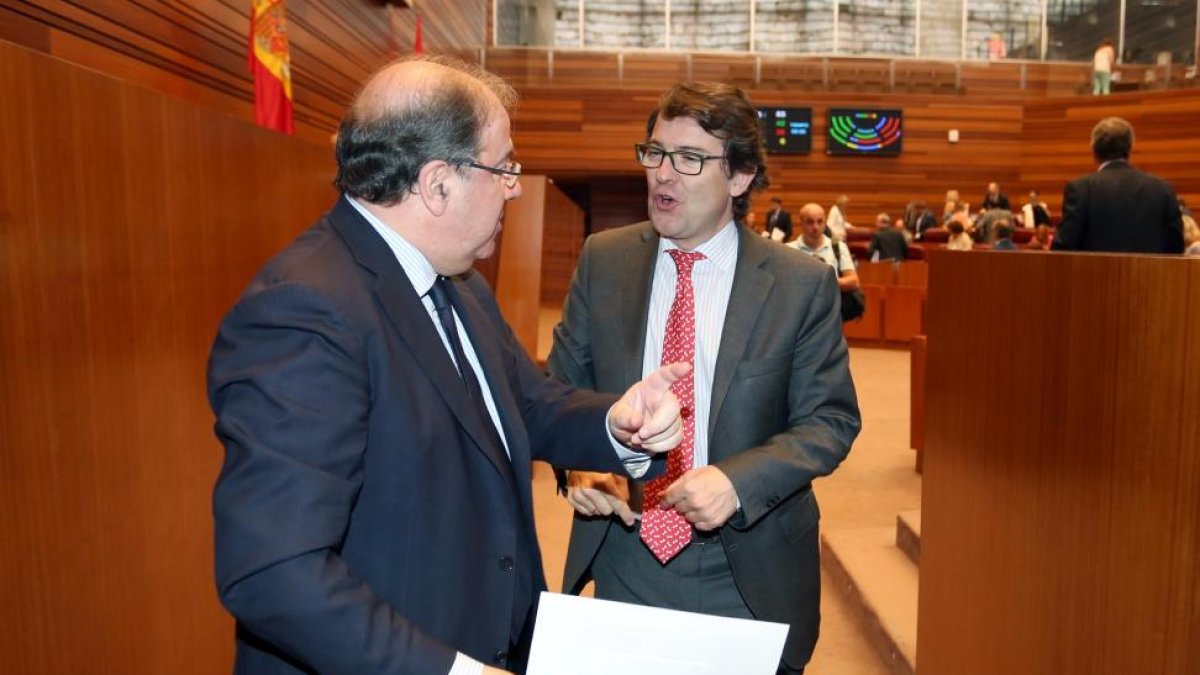 El presidente autonómico del PP y procurador en las Cortes de Castilla y León, Alfonso Fernández Mañueco, conversa con el presidente de la Junta, Juan Vicente Herrera, tras finalizar el Pleno de presupuestos en las Cortes autonómicas-ICAL