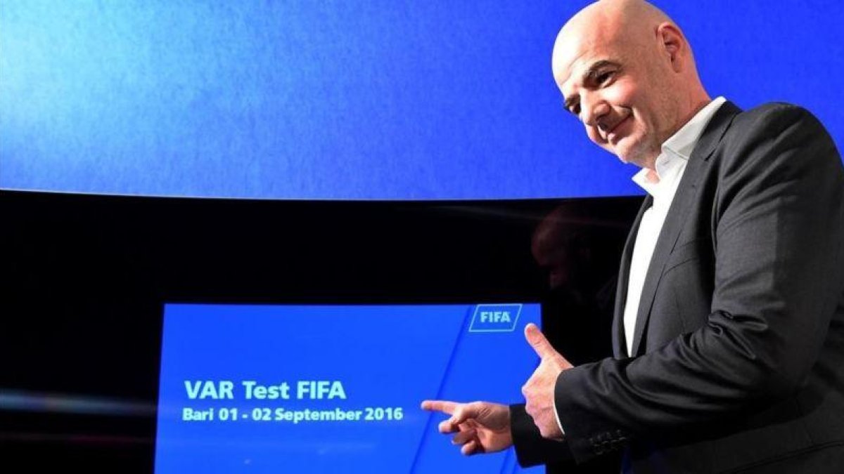 El presidente de la FIFA, Gianni Infantino, ante una pantalla utilizada en el sistema VAR, durante la rueda de prensa de este viernes en Bari.-AFP / ALBERTO PIZZOLI