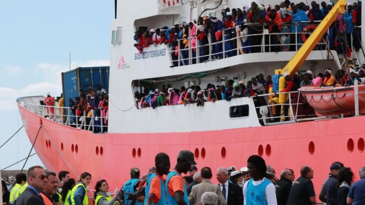 El barco de rescate de Médicos Sin Fronteras llega con 1004 inmigrantes a bordo al puerto de Salerno.-CARLO HERMANN / AFP