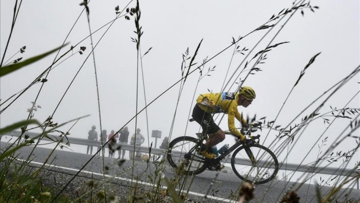 Chris Froome, entre niebla, en el descenso de Puymorens, con el jersey amarillo.-AFP / JEFF PACHOUD