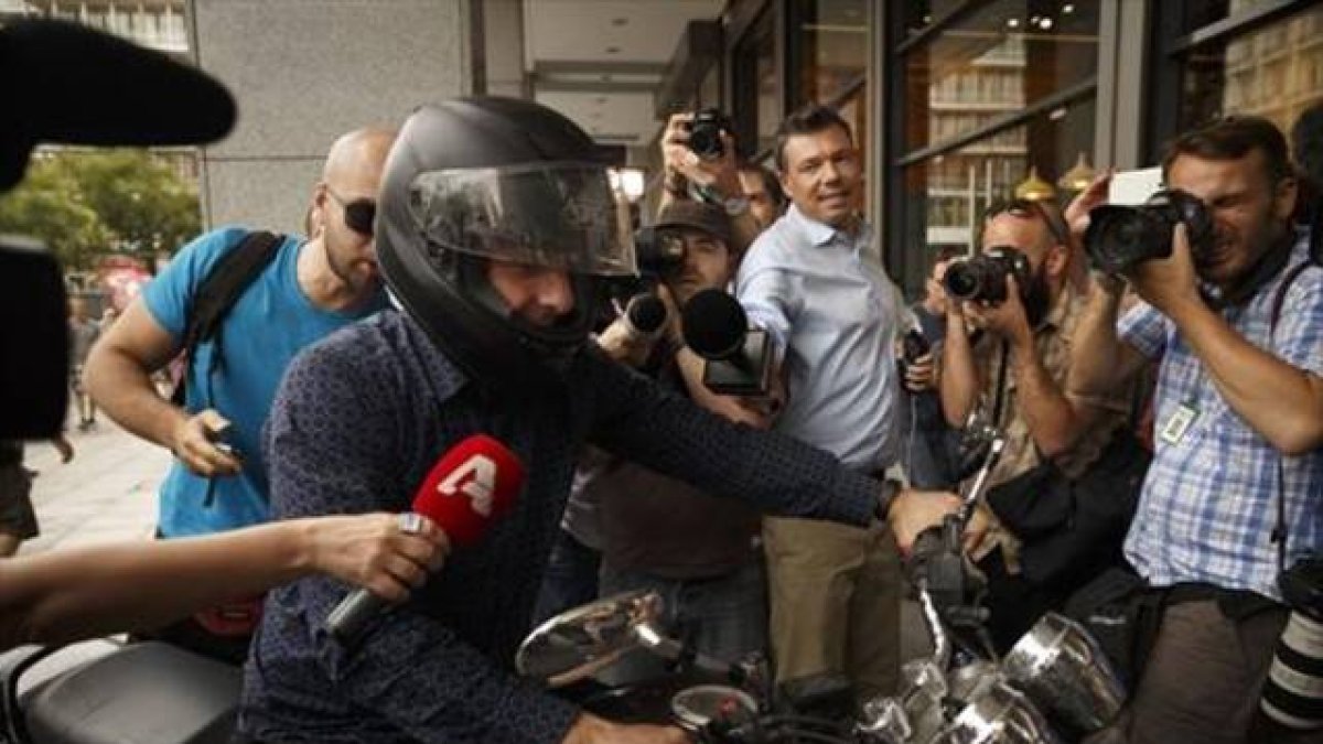 Yanis Varoufakis, rodeado de cámaras al abandonar ayer su oficina.-Foto:   AP /DANIEL OCHOA DE OLZA
