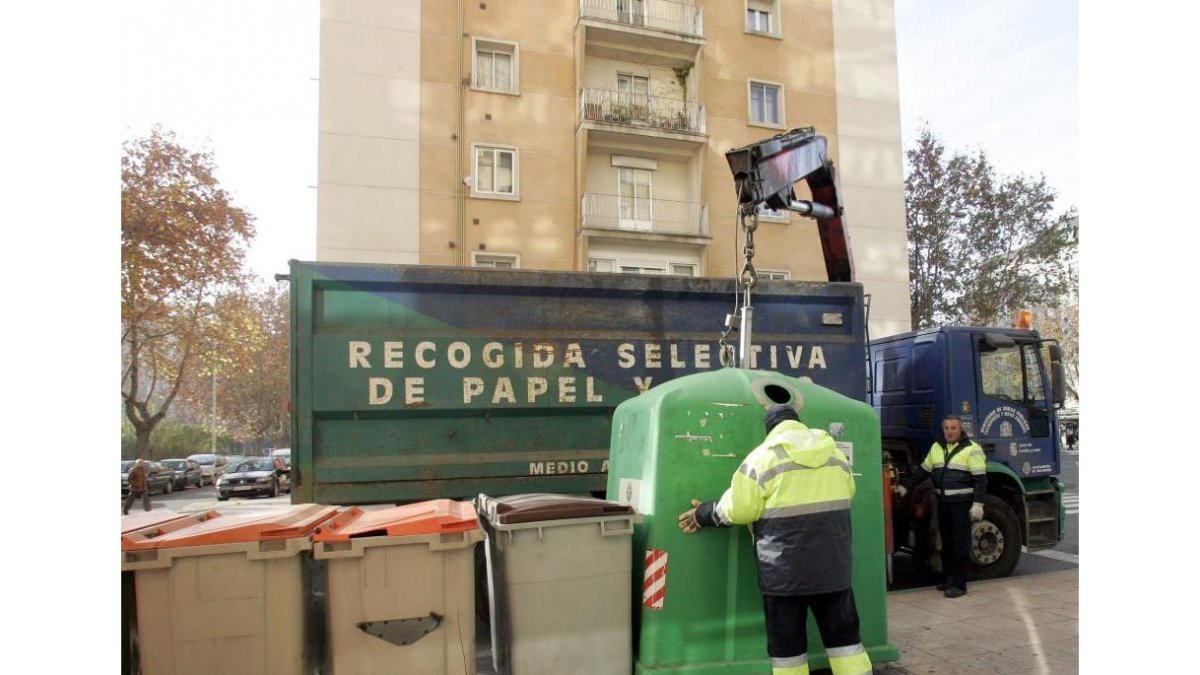 Operarios trabajando en la recogida selectiva del reciclaje de papel y vidrio-ICAL