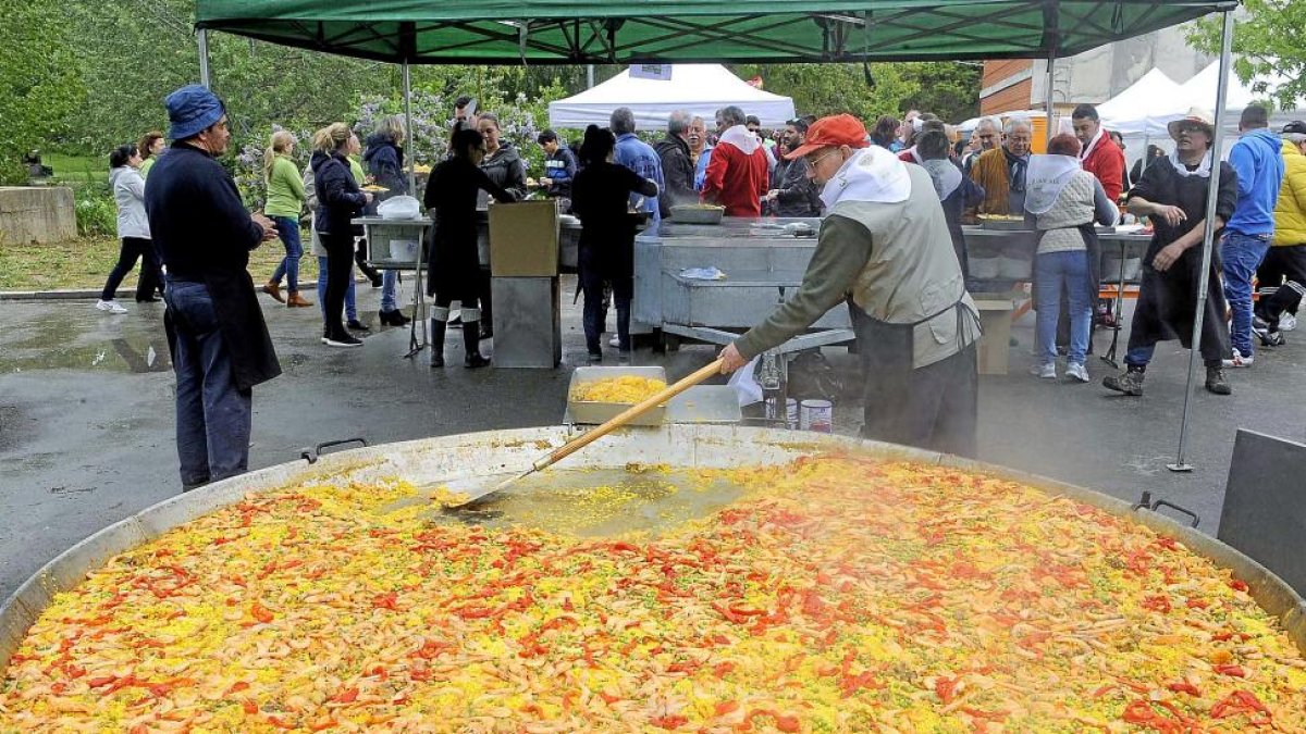Un hombre cocina la paella en Arroyo.-M. FERNÁNDEZ