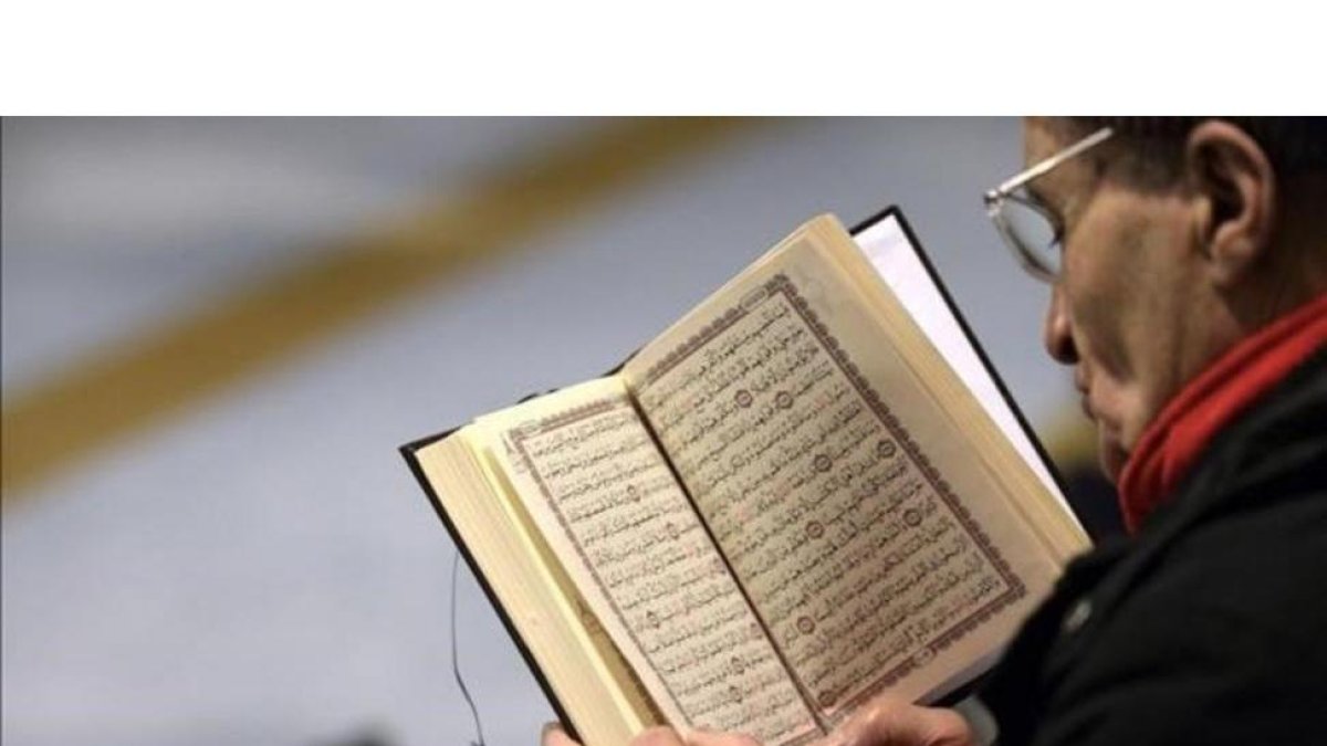 Un muslmán lee el Corán en la Gran Mezquita de Estrasburgo, tras los atentados contra el semanario 'Charlie Hebdo' en el 2015.-PATRICK HERTZOG / AFP