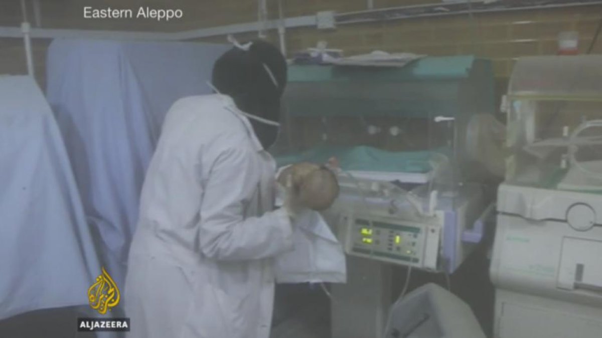 Una enfermera saca a un niño de la incubadora en Alepo.-