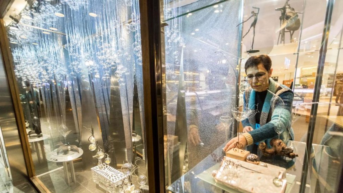 Inmaculada Vara, dueña de la pastelería ‘Belaria’ que conquistó ayer el primer premio, acomoda uno de los vidrios que presenta su escaparate.-PABLO REQUEJO